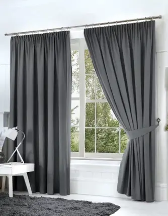 Modern motorized curtains installed on large windows, controlled remotely for easy light and privacy adjustment.