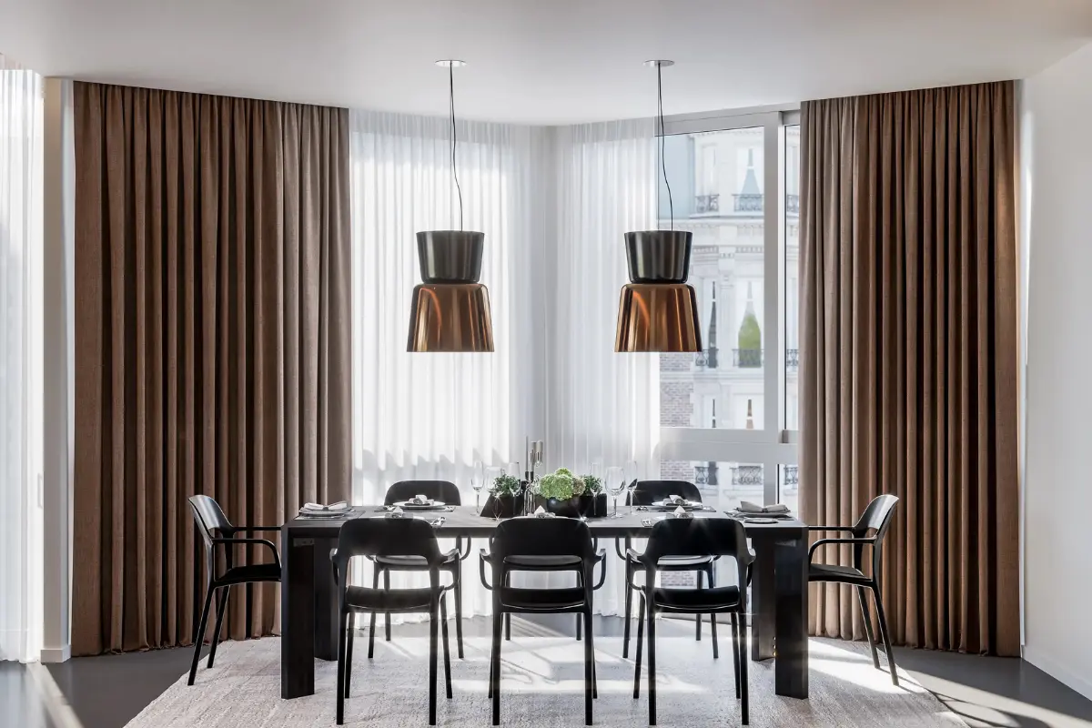 Luxury pinch pleat curtains installed in a modern Abu Dhabi home, featuring tailored pleats and premium fabric finish.